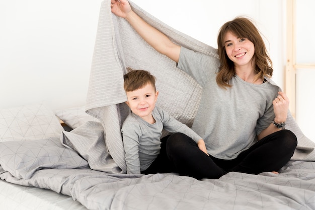 Mother and son laid in bed