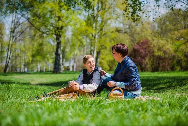 Mother and son laughing outdoors