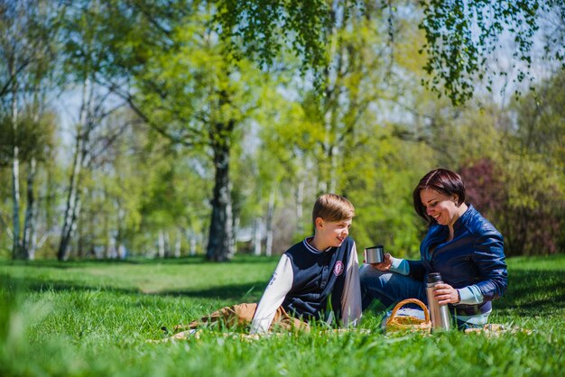 Mother and son laughing in the park