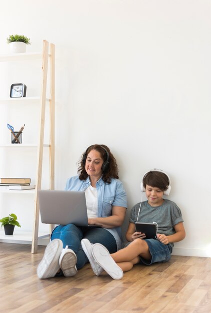 Mother and son looking on laptop