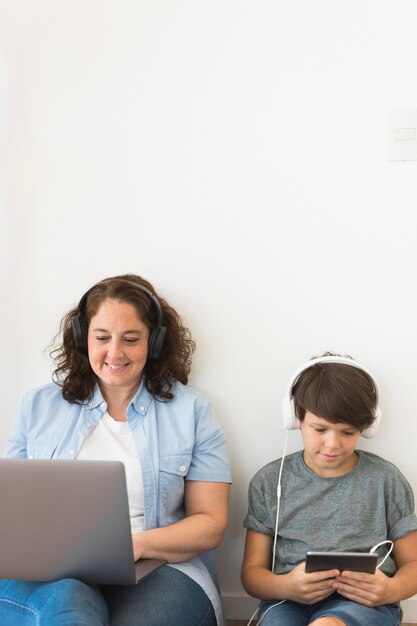 Mother and son looking on laptop
