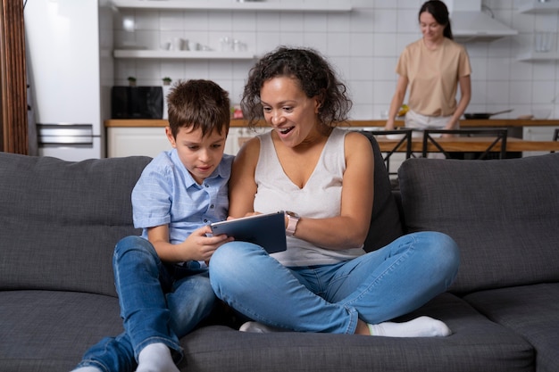 Free photo mother and son looking at a tablet