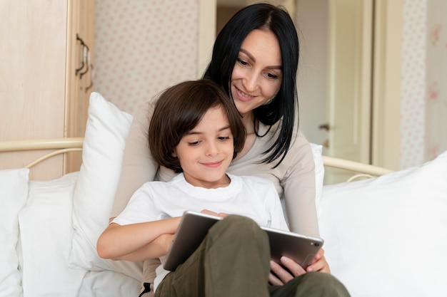 Free photo mother and son looking on a tablet