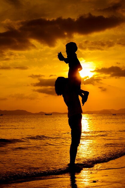 A mother and son in outdoors at sunset with copy space