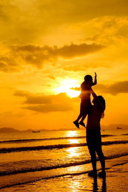 A mother and son in outdoors at sunset with copy space