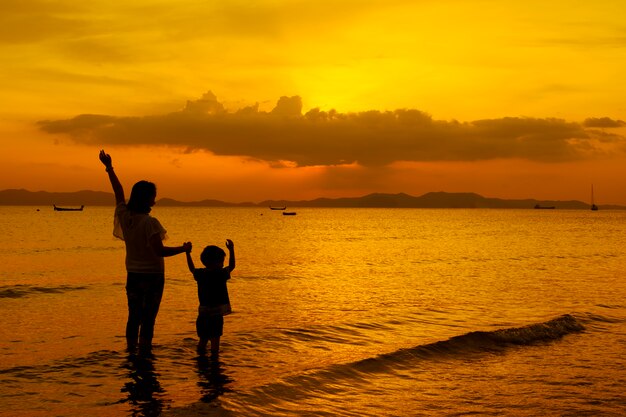 A mother and son in outdoors at sunset with copy space