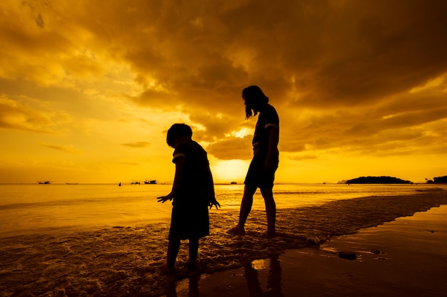 A mother and son in outdoors at sunset with copy space