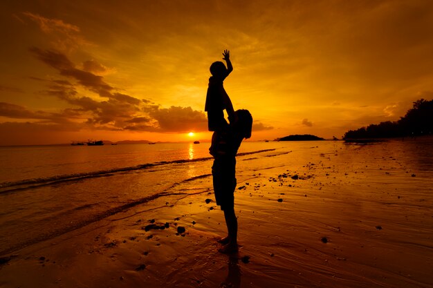 A mother and son in outdoors at sunset with copy space