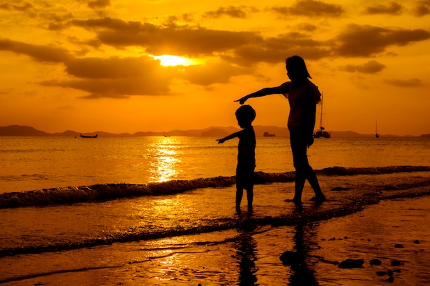 A mother and son in outdoors at sunset with copy space