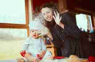 Free photo the mother and son playing with flour