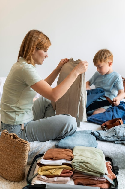 Mother and son preparing a suitcase for their holiday