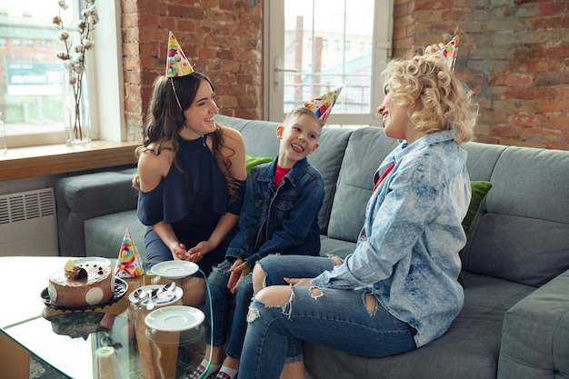 Mother, son and sister at home having fun