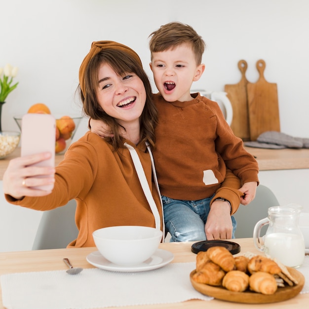 Mother and son taking selfies