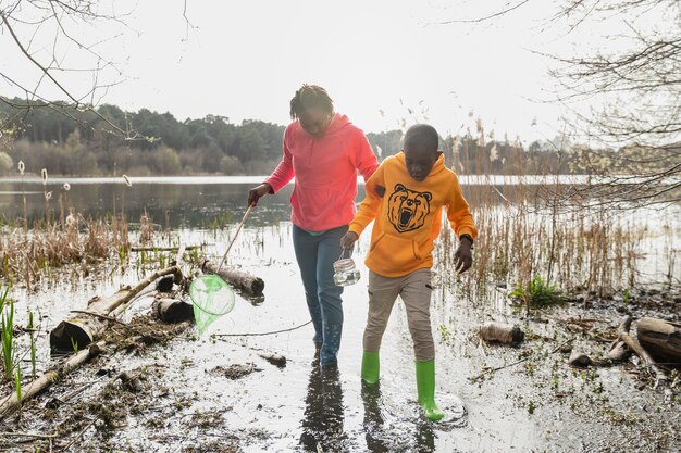 Mother and son walking through a muddy location