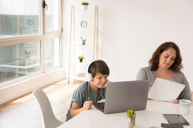 Mother and son working on laptop