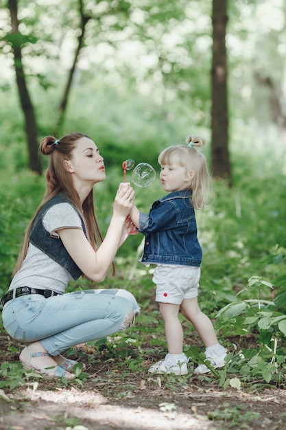 Mother squatting on her daughter's hands