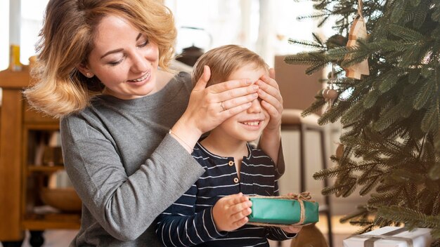 Mother surprising boy with gift