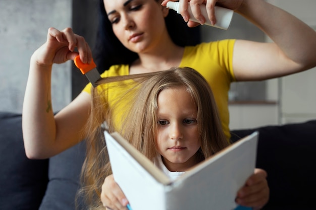 Mother taking care of child with head lices