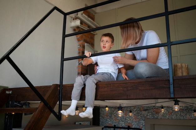 Free photo mother taking care of her autistic son at home