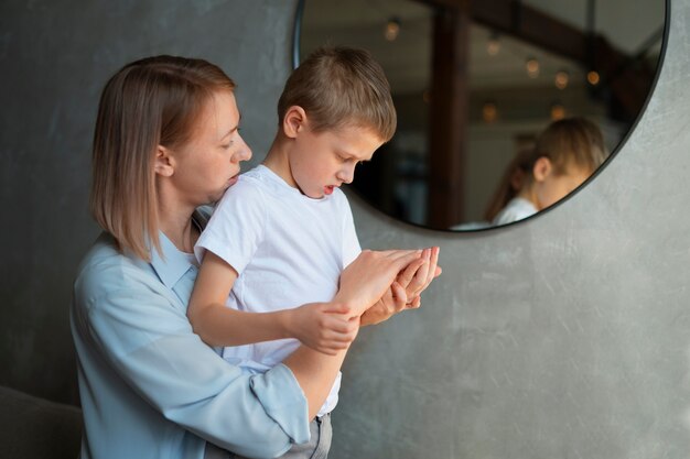 Mother taking care of her autistic son at home