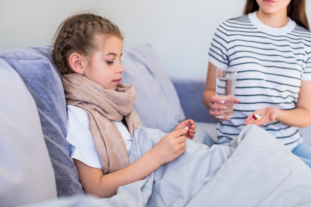 Mother taking care of her ill daughter