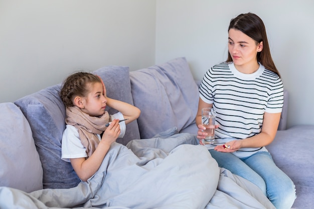 Mother taking care of her ill daughter