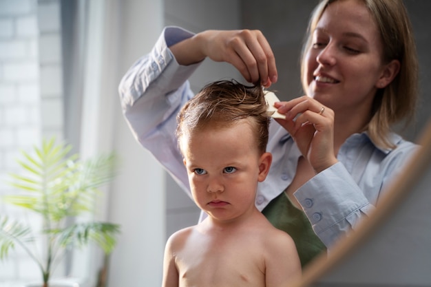 Mother taking care of her kid with lices