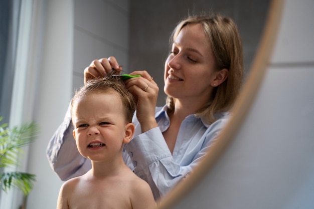 Mother taking care of her kid with lices