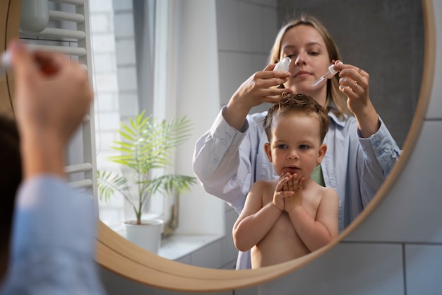 Mother taking care of her kid with lices