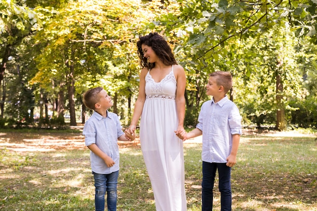 Mother taking a walk in the park with her sons