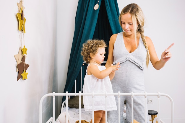 Free photo mother teaching baby