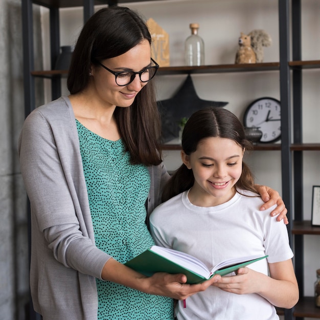 Mother teaching girl to read