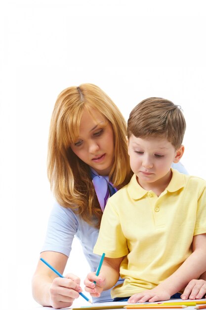 Mother teaching her child to write