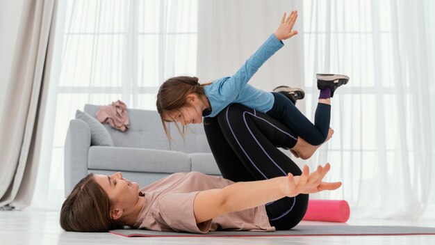 Mother training with child  at home