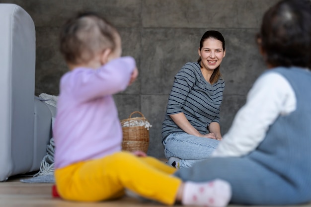 Mother watching babies while they are playing