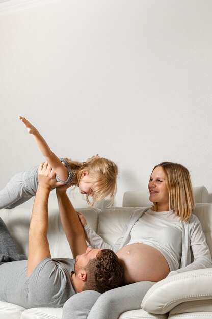 Mother watching father playing with little girl