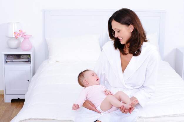 Mother with baby in bedroom