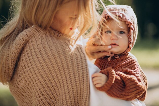 Mother with baby daughter together in park