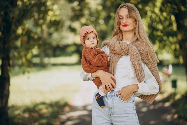 Mother with baby daughter together in park