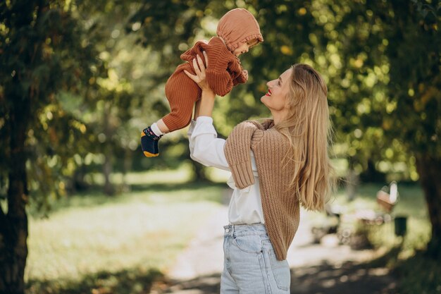 Mother with baby daughter together in park