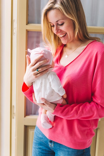 Mother with baby in front of window