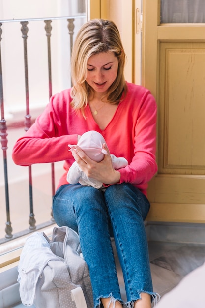 Mother with baby in front of window