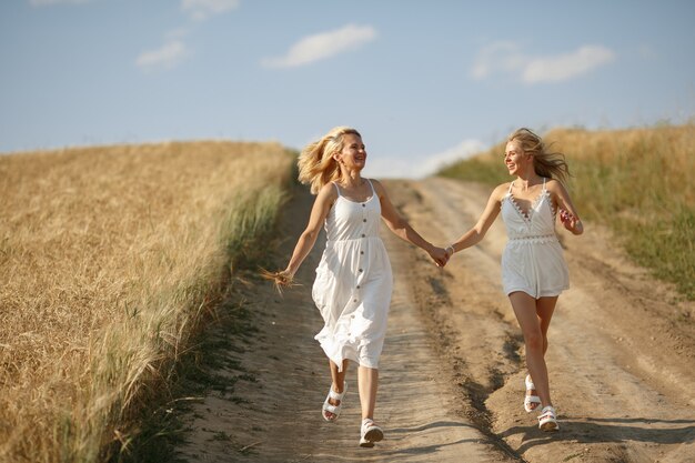 Mother with beautiful daughter in a autumn field