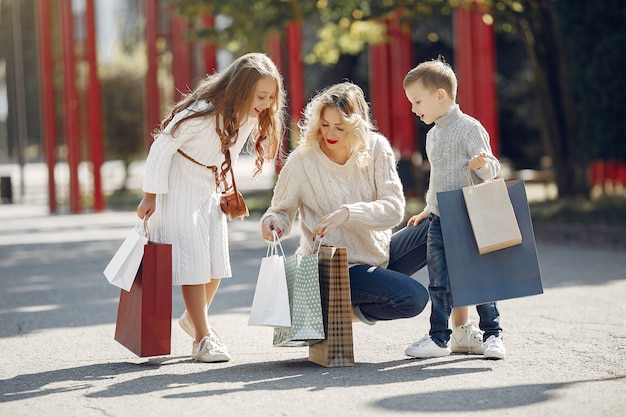mother with child with shopping bag in a city