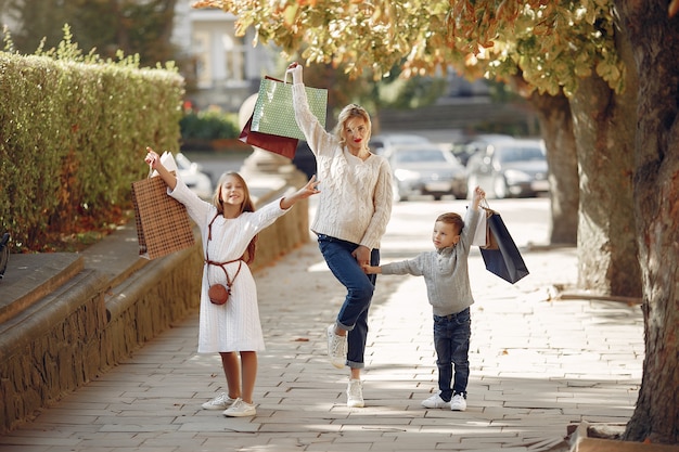 Mother with child with shopping bag in a city