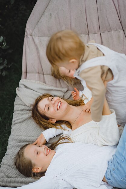 mother with children having fun in a hammock. Mom and kids in a hammock. T