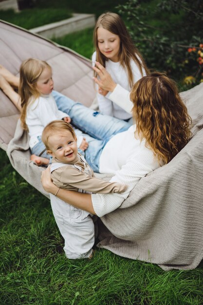 mother with children having fun in a hammock. Mom and kids in a hammock. 