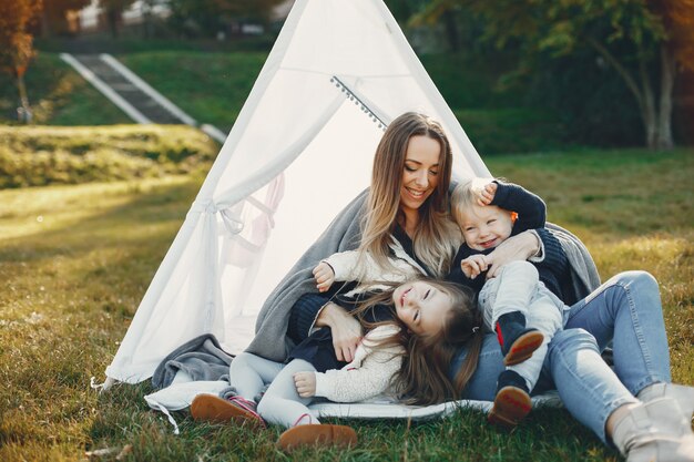 Mother with children playing in a summer park