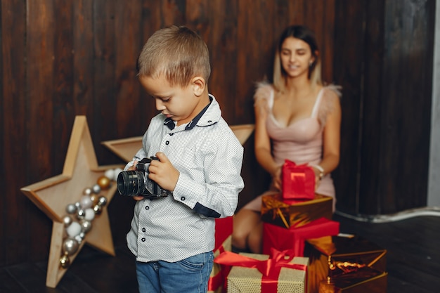 Mother with cute son celebrating Christmas