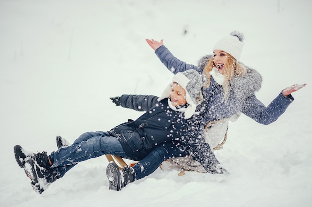Free photo mother with cute son in a winter oark